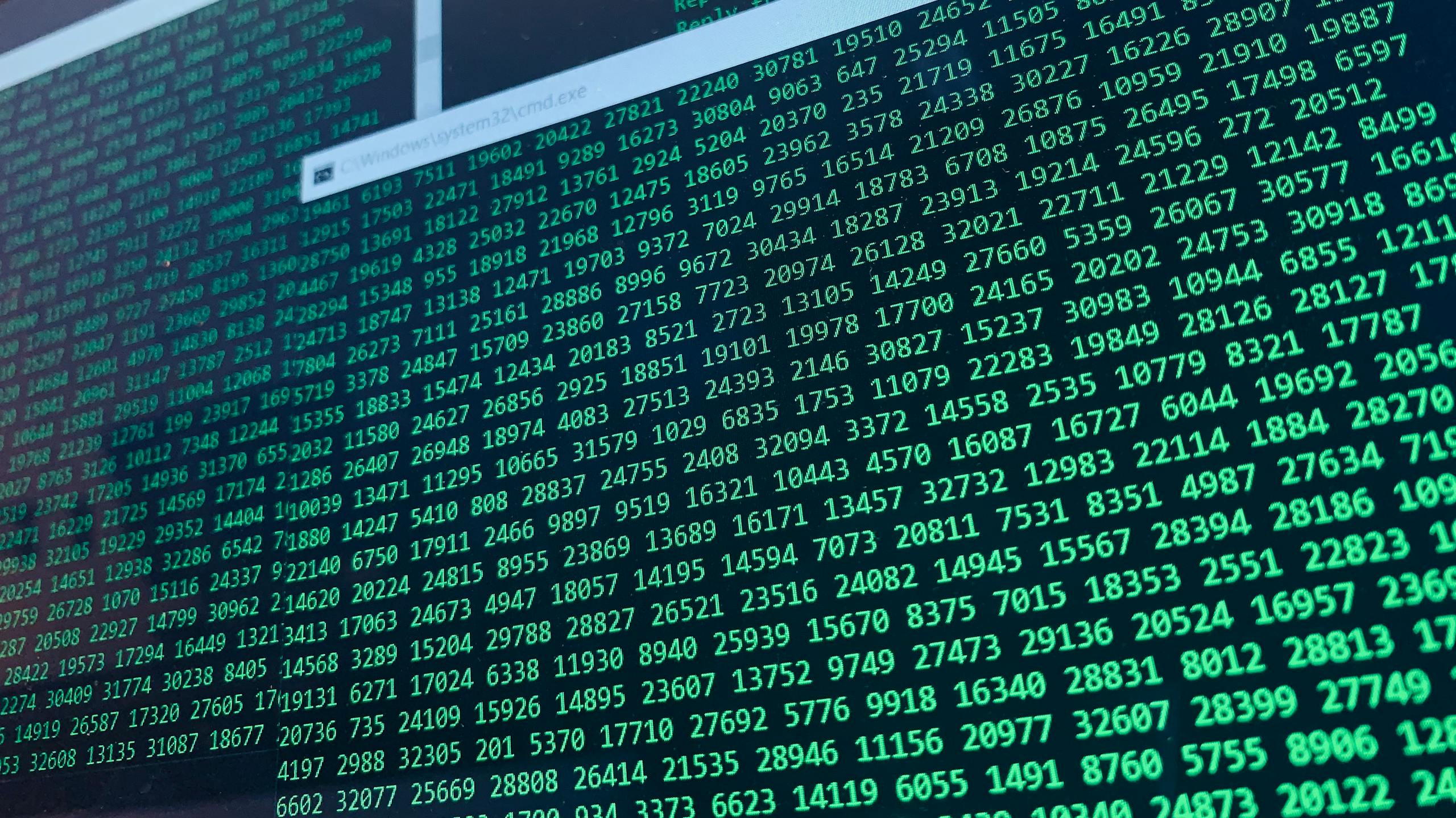 Vibrant green numbers on a computer screen, showcasing binary code and data streams.